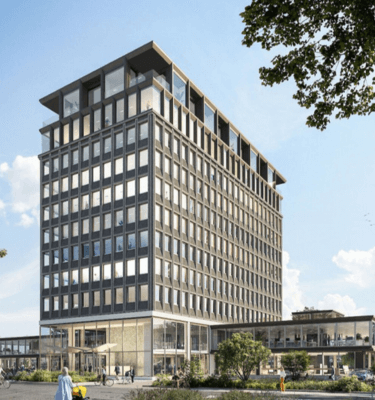 Staal-Kade Amsterdam: een modern, duurzaam kantoorgebouw met strakke architectuur, grote ramen en groen in de omliggende omgeving.