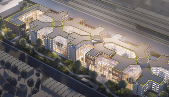 Luchtfoto van het nieuwe ABN AMRO-hoofdkantoor in Amsterdam met moderne architectuur en veel glazen panelen.