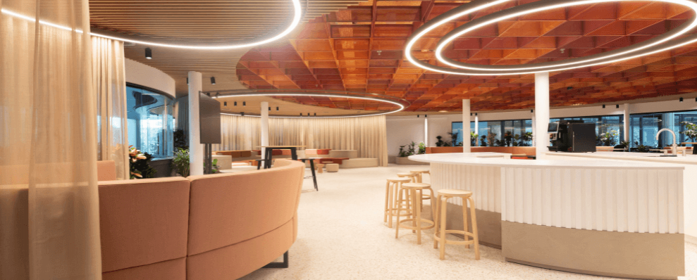 Modern interieur van EDGE Stadium met ronde LED-verlichting, houten plafondelementen en een open, uitnodigende werkruimte.